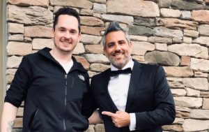 owner of only one tailoring and gentleman pointing at him wearing a bespoke suit