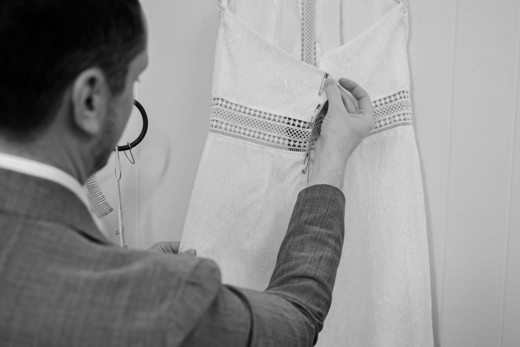 man making a dress black and white scale